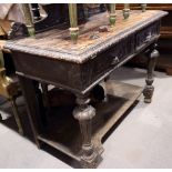 A 19th century carved oak side table with ledge back, fitted two drawers and undertier, 42" wide