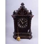 A 19th century Gothic carved oak cased cuckoo clock with fusee movement, 32" high