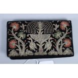 A 1930s silver wire embroidered velvet and silk lined evening purse, decorated fountain, birds and