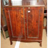 A figured mahogany side cupboard enclosed two panelled doors, on splay bracket supports, 30" wide