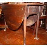 An oak drop leaf dining table, on turned supports, 36" wide