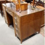 A Heal's 1930s figured walnut double pedestal desk, fitted three-section leather inset top and