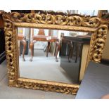 A Florentine carved giltwood scrollwork framed wall mirror, plate 23" x 18"
