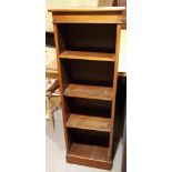 A mahogany open bookcase with adjustable shelves, on block base, 17" wide