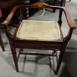 An Edwardian box seat music stool, on square taper supports