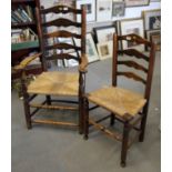 A 19th century ash ladder back elbow chair with rush envelope seat and a companion standard chair