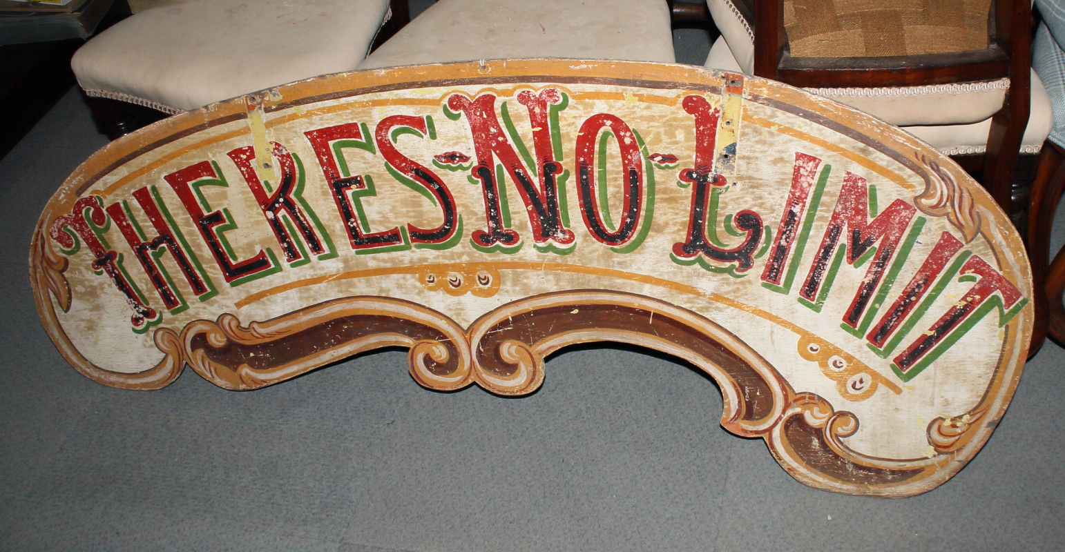 A double-sided fairground sign, "Step on the Gas" and "There's no Limit" verso, 58" long