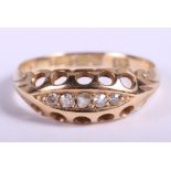 An 18ct gold and diamond dress ring set five stones, size L/M, 2.1g gross