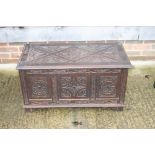 A carved oak blanket box with triple-panel front, 36" wide