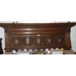 A 19th century carved oak coat rack with brass hooks and florette panels, 60" wide