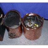 A copper log pail, two copper scuttles and a pair of brass candlesticks