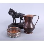 A 19th century cast iron horse doorstop, a Middle Eastern coffee pot, and a silver plated bottle