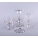 A Georgian cut glass rummer, two engraved rummers and a Georgain bell bowl wine glass with folded