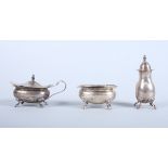 A silver three-piece cruet set, each raised on four paw feet, Birmingham 1975