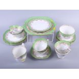 A Continental porcelain part dinner service, decorated green floral borders, sixty-five pieces