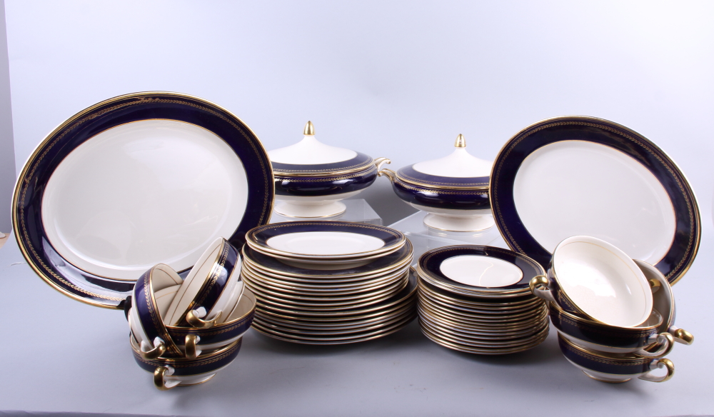 A Simpsons Ambassador Ware part dinner service with dark blue borders and gilt husk decoration