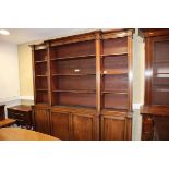 A 19th century mahogany breakfront library bookcase, the upper section fitted open shelves over