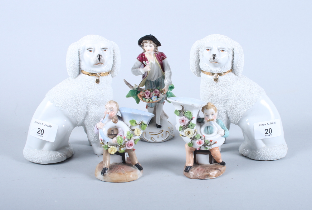 A pair of Staffordshire design poodles, a Sitzendorf porcelain figure of a flower seller and a