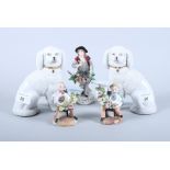 A pair of Staffordshire design poodles, a Sitzendorf porcelain figure of a flower seller and a