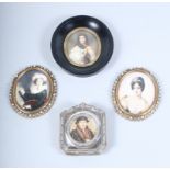 A silver miniature photograph frame together with four miniature portraits, various