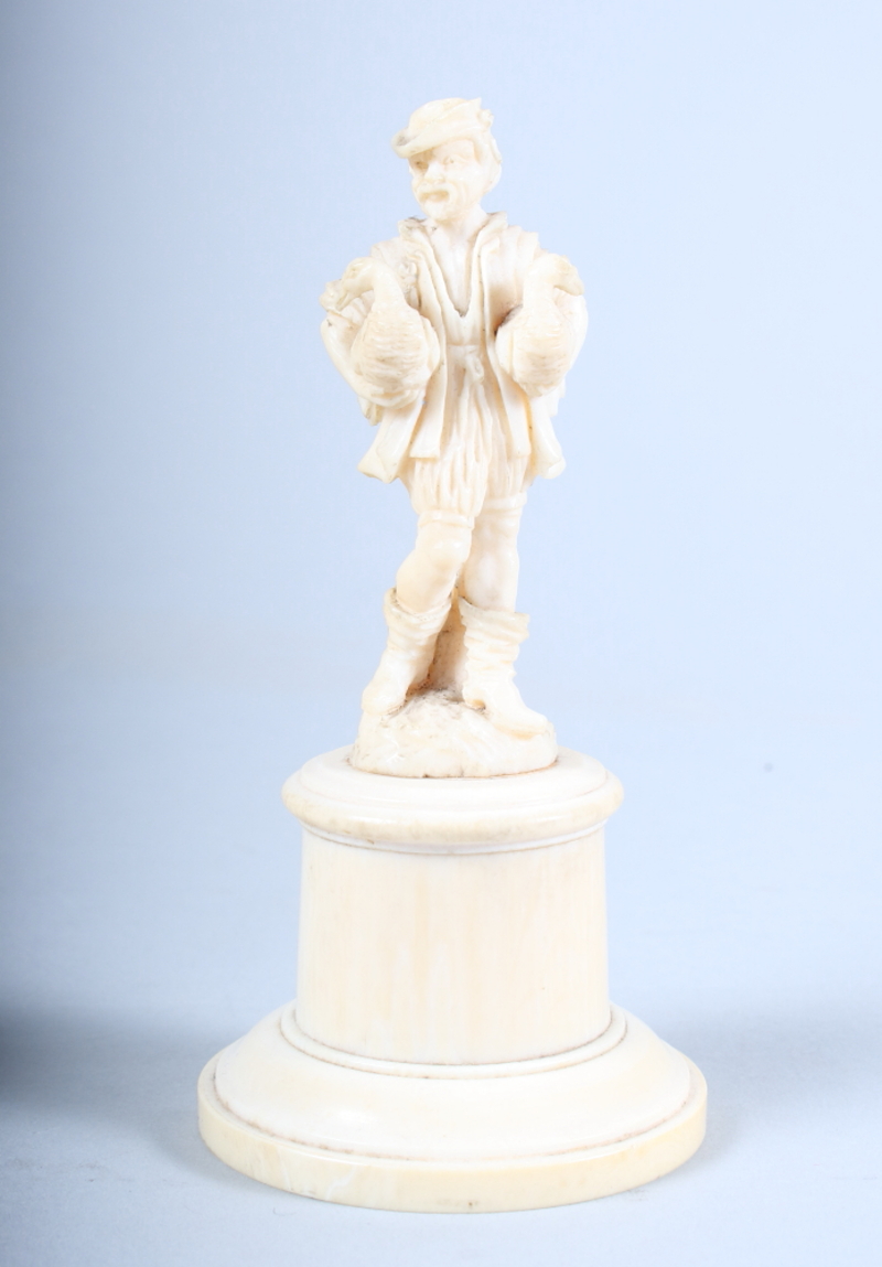 A 19th century Dieppe carving of a gentleman with geese under his arms, on plinth base, 4 1/2" high