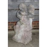 A carved composite stone statue of entwined lovers, 36" high