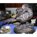 A bronze model of a cock pheasant and lizard, on black marble base, 23" high