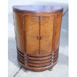 A 1930s walnut bowfront cupboard