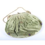 A lady's early 20th century green velvet evening bag with brass and various glass jewels