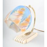 An Art Deco Bakelite and brass table lamp with blue and orange glass shade