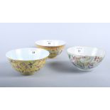 A Chinese porcelain bowl, decorated birds and prunus blossom on a yellow ground, four character mark