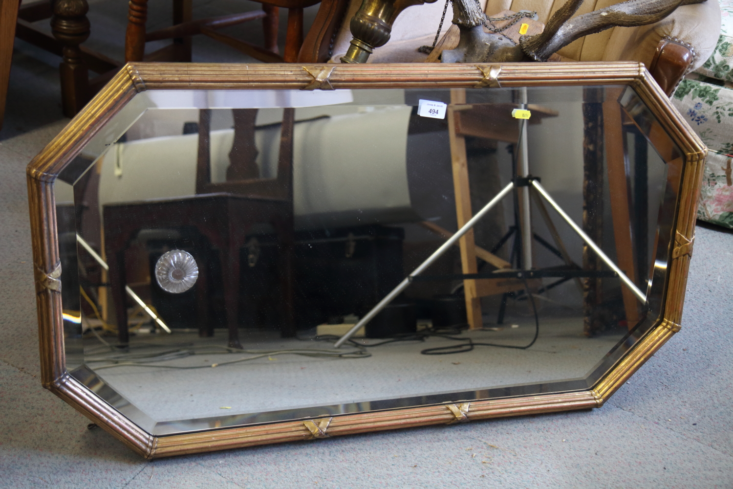 An Edwardian fillet and reed framed wall mirror with cut corners plate, 20" x 37"