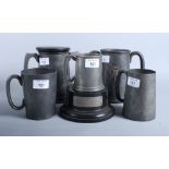 Five assorted pewter trophy cups and plinths