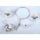 A quantity of assorted silver including a tea strainer, two dressing table jars with lids, an engine