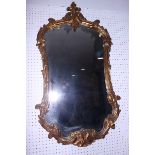 An oval wall mirror, in gilt plaster frame, 25" x 19"