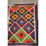 A multi-coloured kelim rug with geometric design, 58" x 40" approx, and a similar smaller rug, 50" x