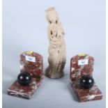 A pair of rouge marble bookends with ball decoration, 5" high, and a carved stone figure of a