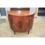 A mahogany and banded bowfront side cupboard enclosed panelled door, on square taper supports, 42"