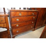 A 19th century oak chest of two short and three long drawers with oval brass handles, on bracket