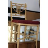 A cream painted faux bamboo framed bedroom chair and a rectangular bevelled wall mirror in stained