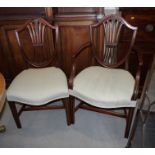 A set of eight late 18th century mahogany dining chairs of Hepplewhite design with pierced