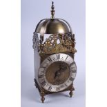 A brass lantern clock of 17th century design with silvered chapter ring, 16" high