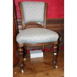 A Victorian standard chair with scroll shaped back, on turned and fluted supports, and a Queen