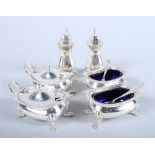 A silver ten-piece cruet set, comprising two salts, two pepperettes, two lidded mustard pots and