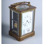 A French early 20th century brass and four glass carriage clock with white enamelled dial and