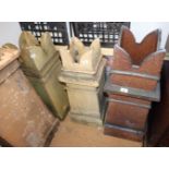 A pair of square cream stoneware chimney pots with shaped tops, 30" high, and a similar larger brown