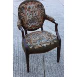 An early 19th century mahogany framed open armchair with oval back and stuffed over seat,