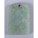 A Chinese celadon jade tablet, carved with a rotund Buddha to one side, 2 1/4" high