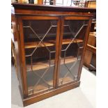 A mahogany bookcase enclosed lattice glazed doors, on block base, 40" wide