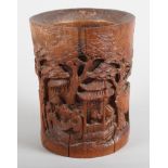An early 19th century Chinese bamboo brush pot, carved numerous figures in a bamboo grove
